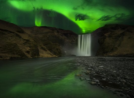 waterfall in Iceland with Northern Lights
